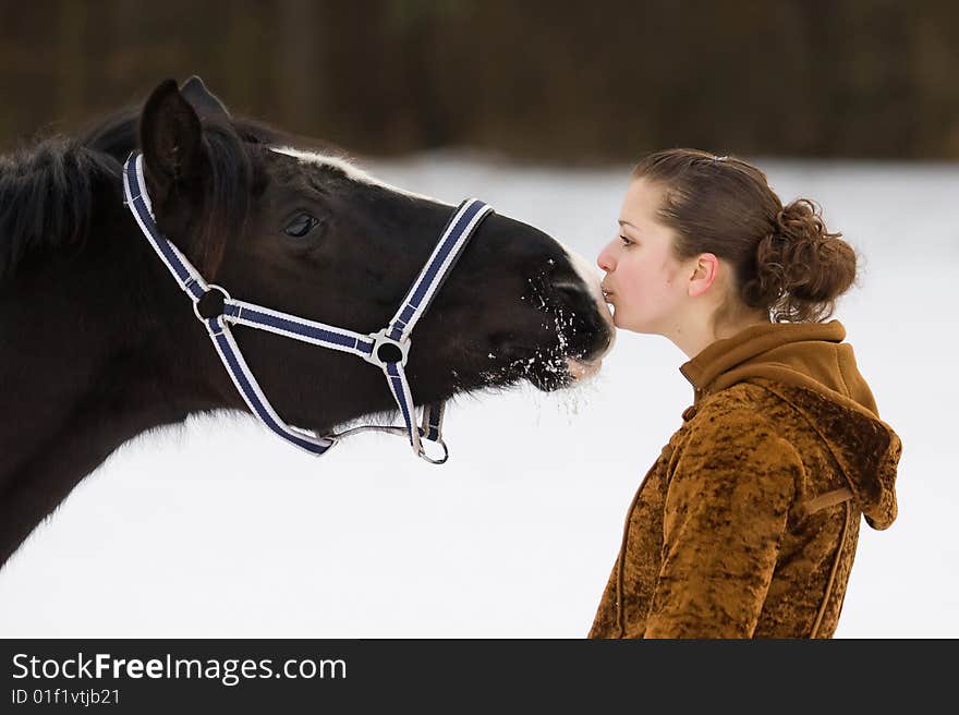 A girl kisses a horse. A girl kisses a horse