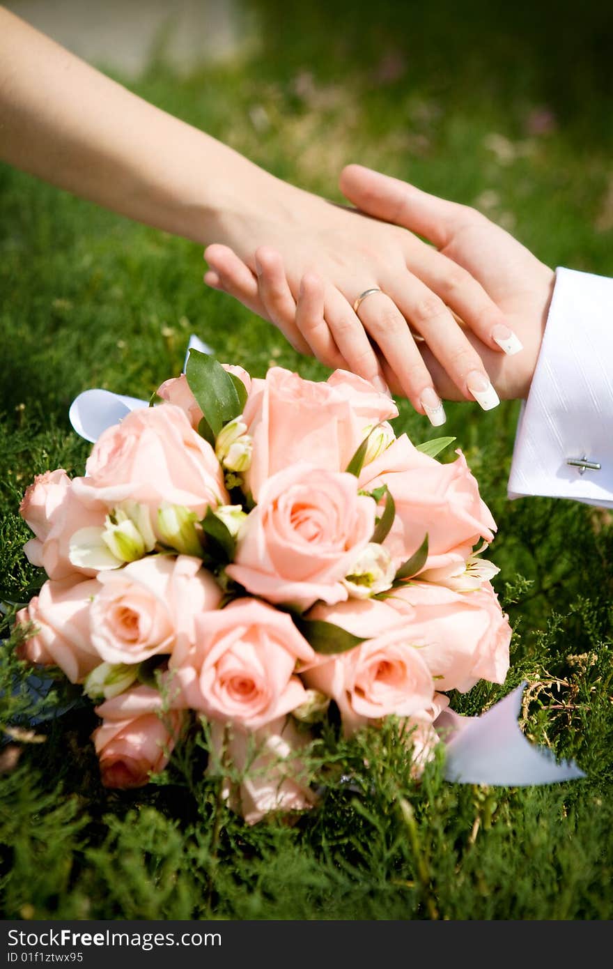 Two hands over flower bouquet. Two hands over flower bouquet