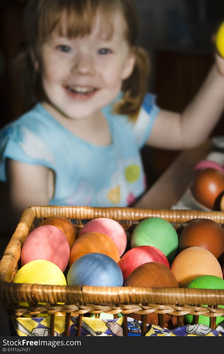 Child hands holding a multi colored egg. Child hands holding a multi colored egg.