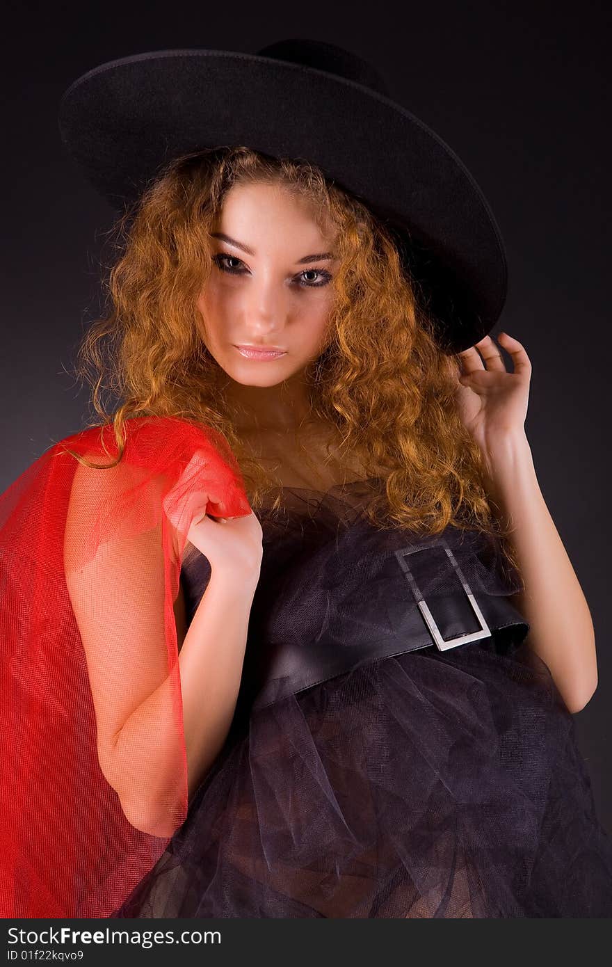 Beautiful red-haired girl in hat, studio shot