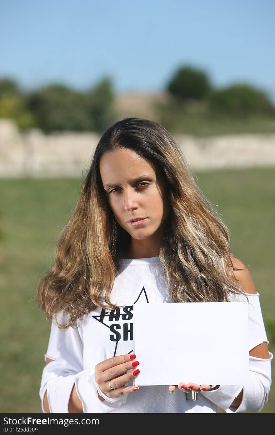 Portrait of a beautiful woman holding a white card