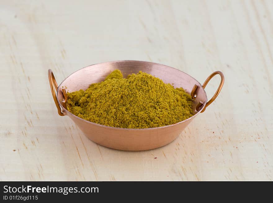 Picture of frying pan isolated in background of wood with curry. Picture of frying pan isolated in background of wood with curry