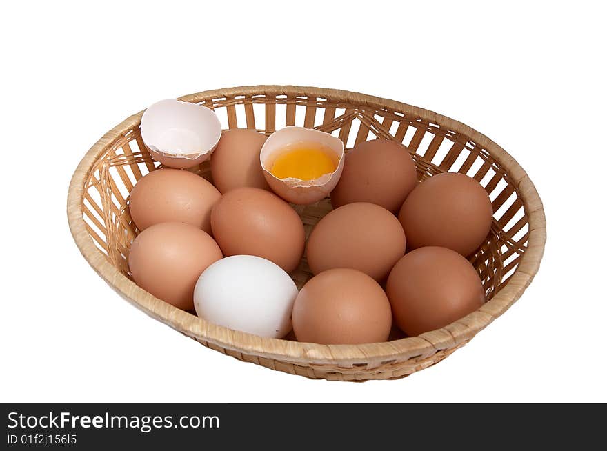 Chicken eggs in the brown basket.