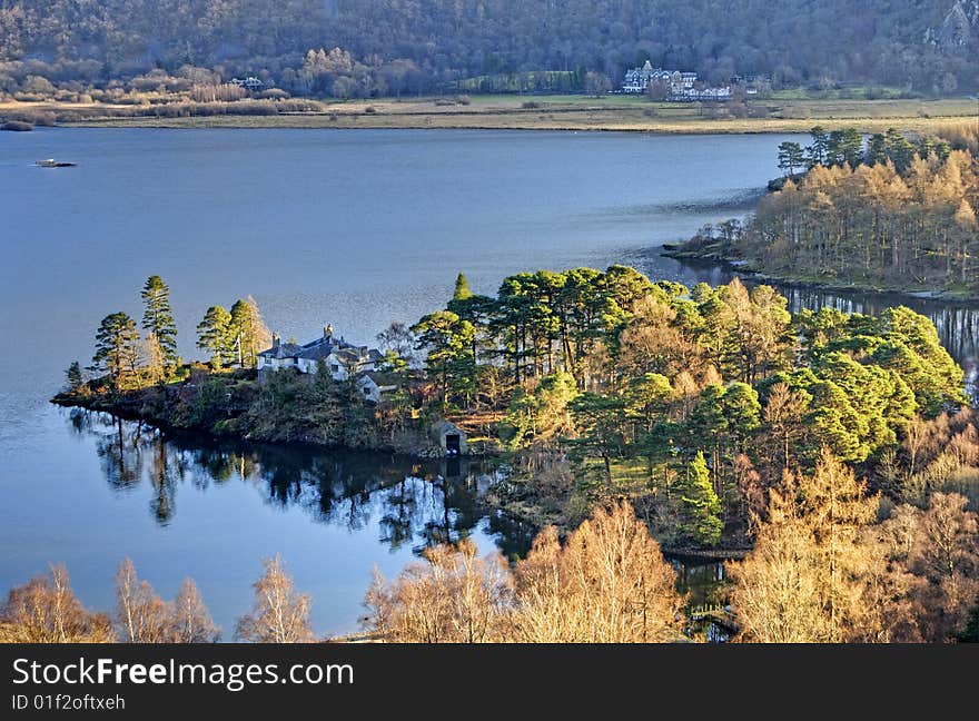 A house on a small peninsular at the edge of Derwent Water in the English Lake District. A house on a small peninsular at the edge of Derwent Water in the English Lake District