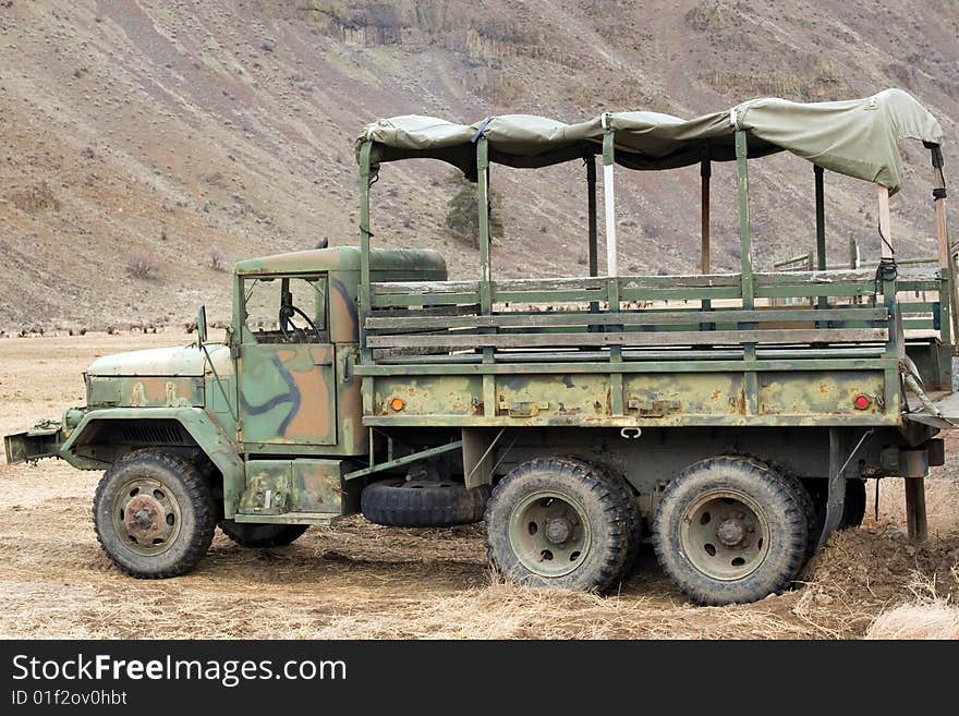 Old diesel flatbed truck parked in field. Old diesel flatbed truck parked in field.