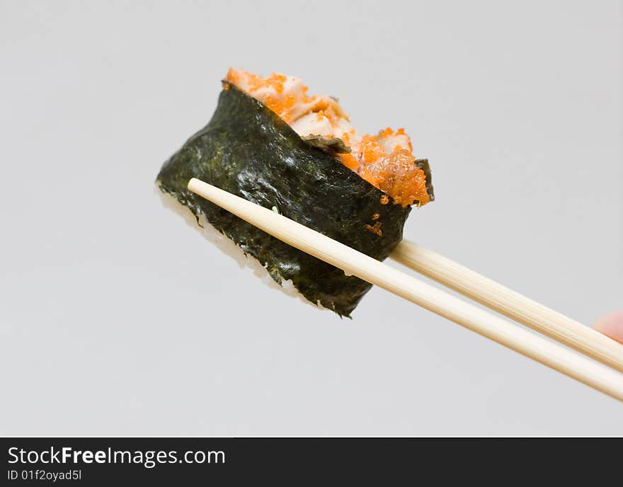 Sushi and chopsticks on the neutral background