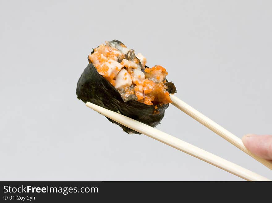 Sushi and chopsticks on the neutral background