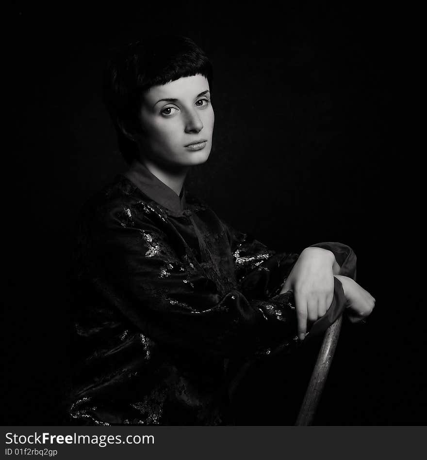 Low key black and white portrait of a young woman