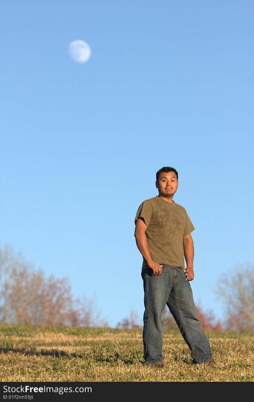 Young guy standing on a field. Young guy standing on a field