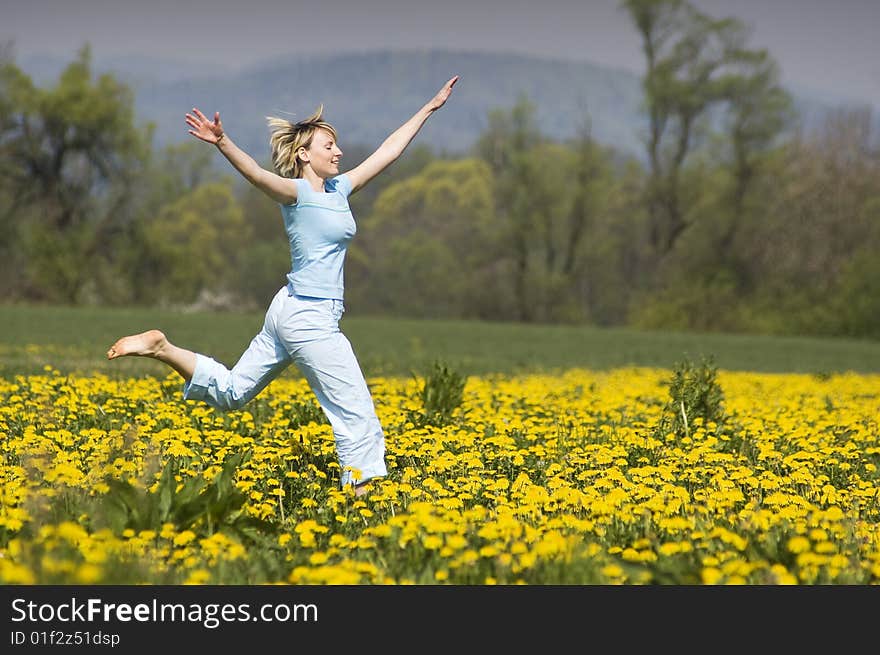 Young blond happy woman running on grass. Young blond happy woman running on grass