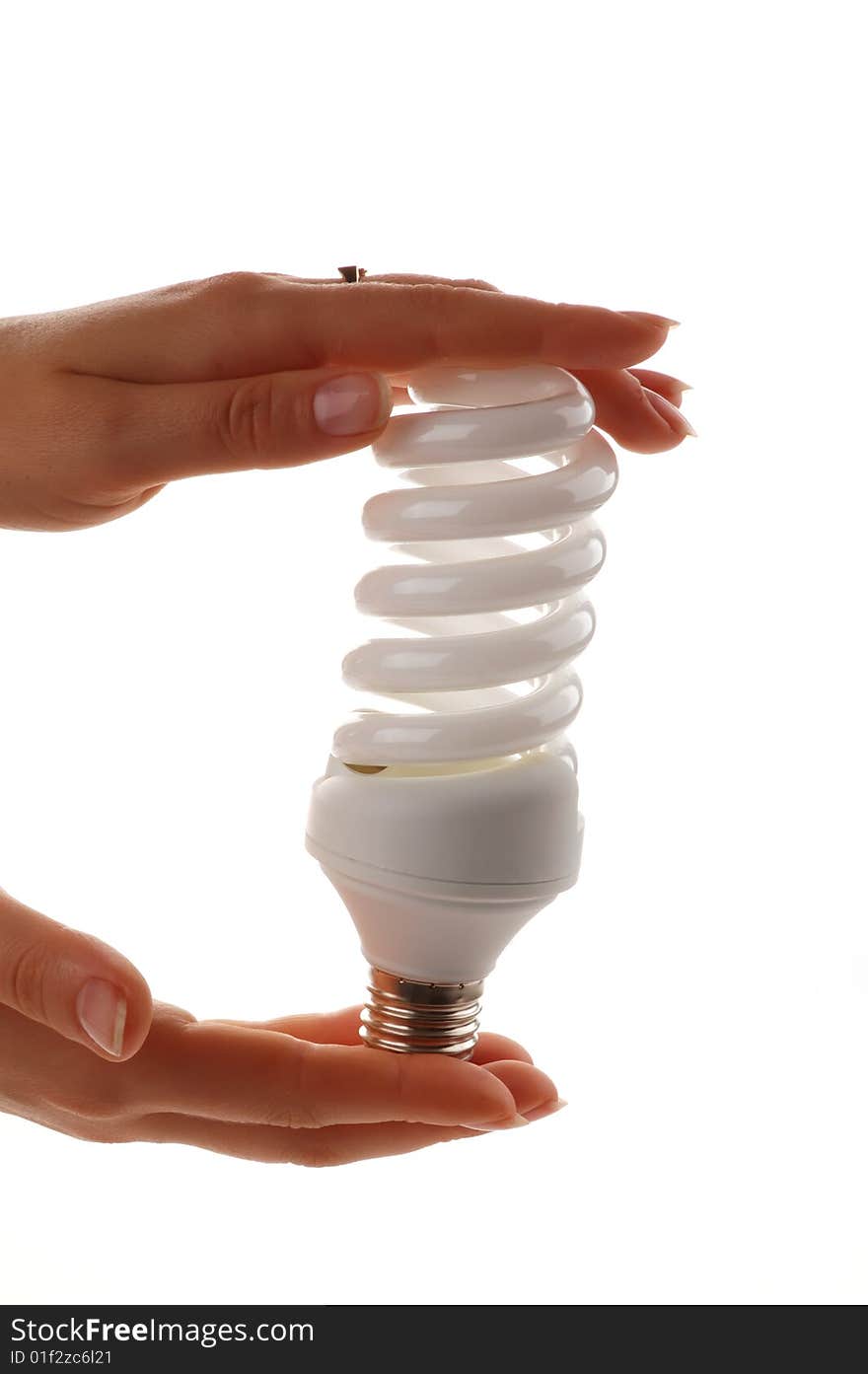 Energy saver lamp in the hands on white background