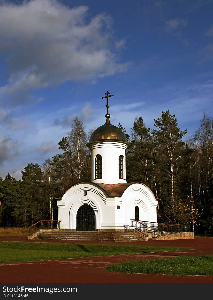 A white chapel on a forest background