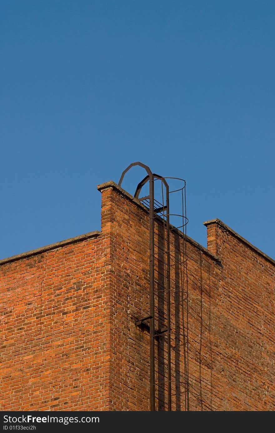 The metal  staircase on the brick wall of building. The metal  staircase on the brick wall of building