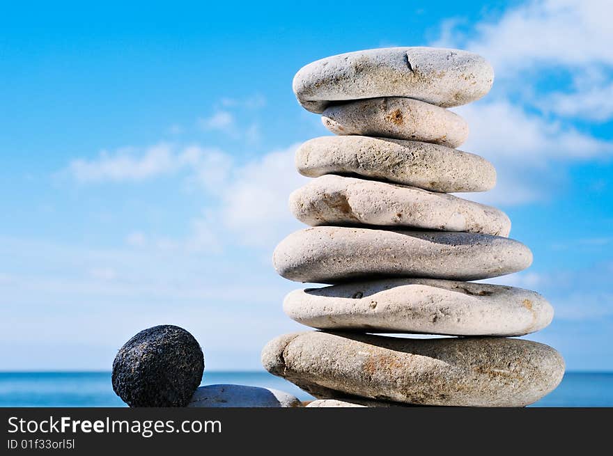 Pile of a sea pebble and black stone on a beach at midday. Pile of a sea pebble and black stone on a beach at midday