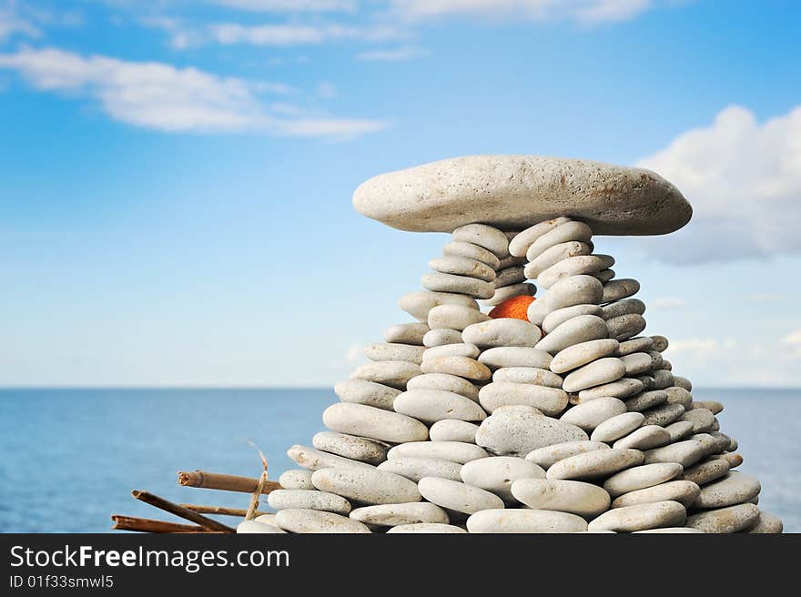 Pyramid from a sea pebble with a red stone inside. Pyramid from a sea pebble with a red stone inside