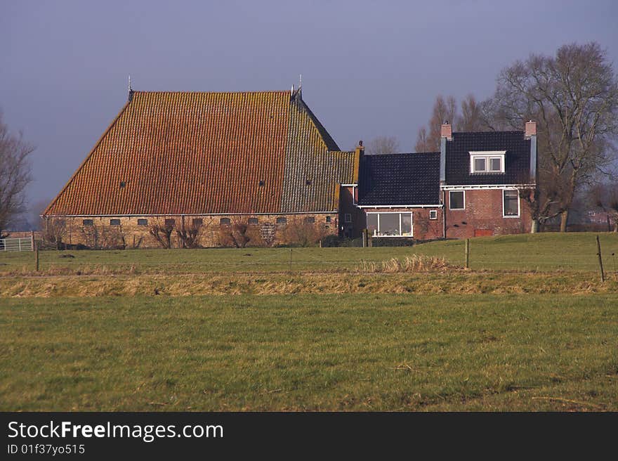 Ancient Frisian farmhouse with a huge barn. Ancient Frisian farmhouse with a huge barn.