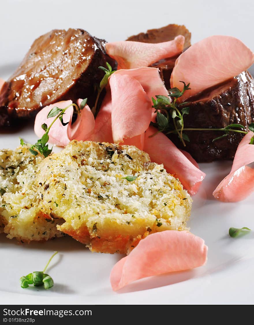 Beef Plate with Potatoes Galette Served with Boiled Rose Petal and Wine Sauce. Isolated on White Background