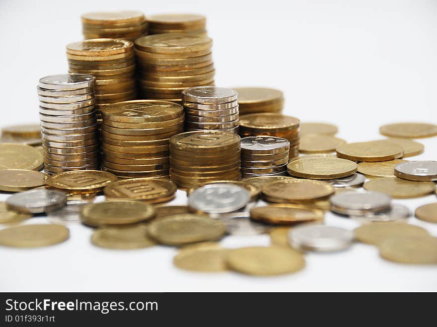 Different coins stacked on white background