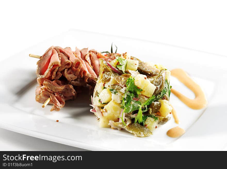 Roast Beef Served with Salad (Potatoes and Vegetables) and Cherry Tomato. Isolated on White Background