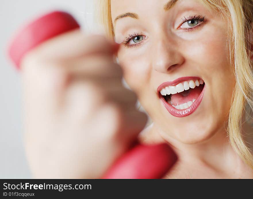 Attractive young woman excercising against a white background. Attractive young woman excercising against a white background.