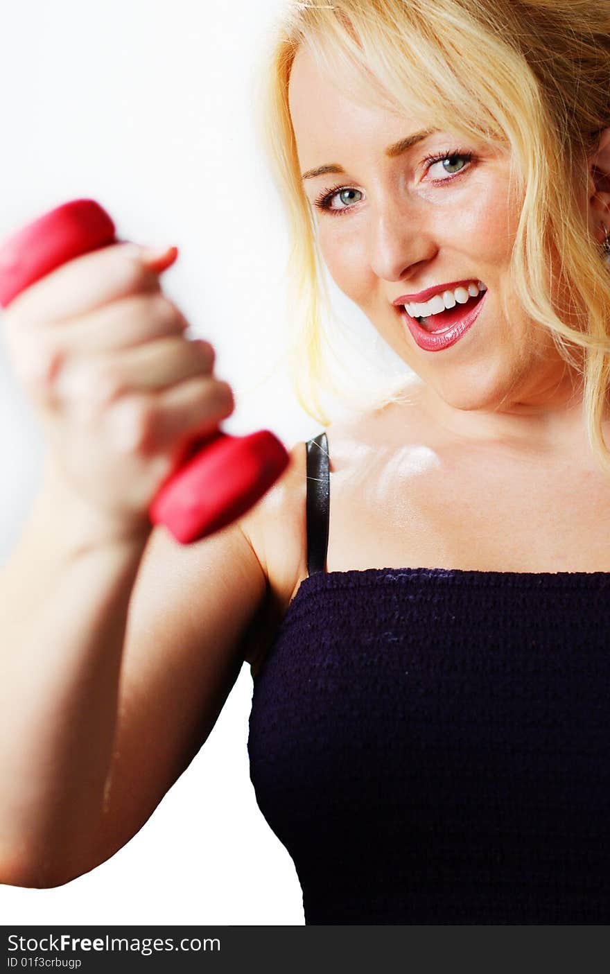 Attractive young woman excercising against a white background. Attractive young woman excercising against a white background.