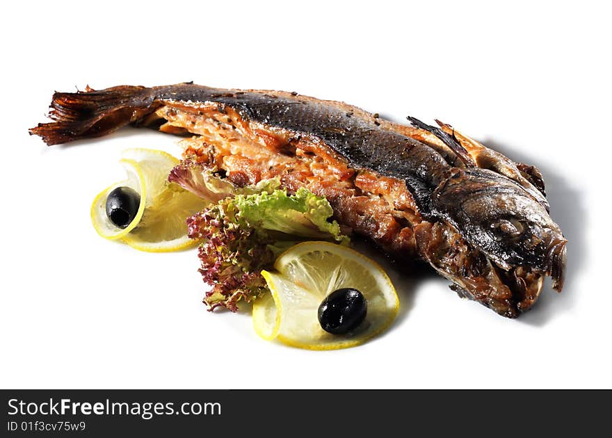 Fish Baked in Spicy Served with Salad Leaves, Lemon and Olives. Isolated on White Background. Fish Baked in Spicy Served with Salad Leaves, Lemon and Olives. Isolated on White Background