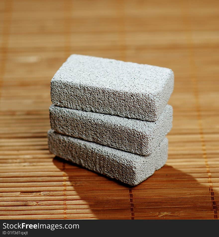 Stack of pumice stones on top of a bamboo mat. Stack of pumice stones on top of a bamboo mat.