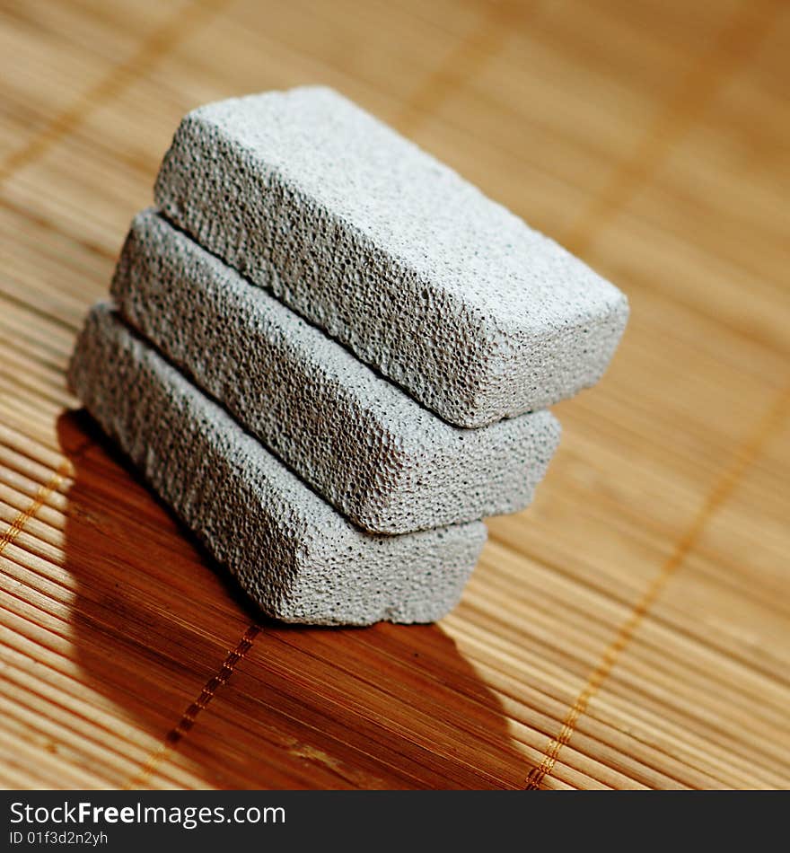 Stack of pumice stones on top of a bamboo mat. Stack of pumice stones on top of a bamboo mat.