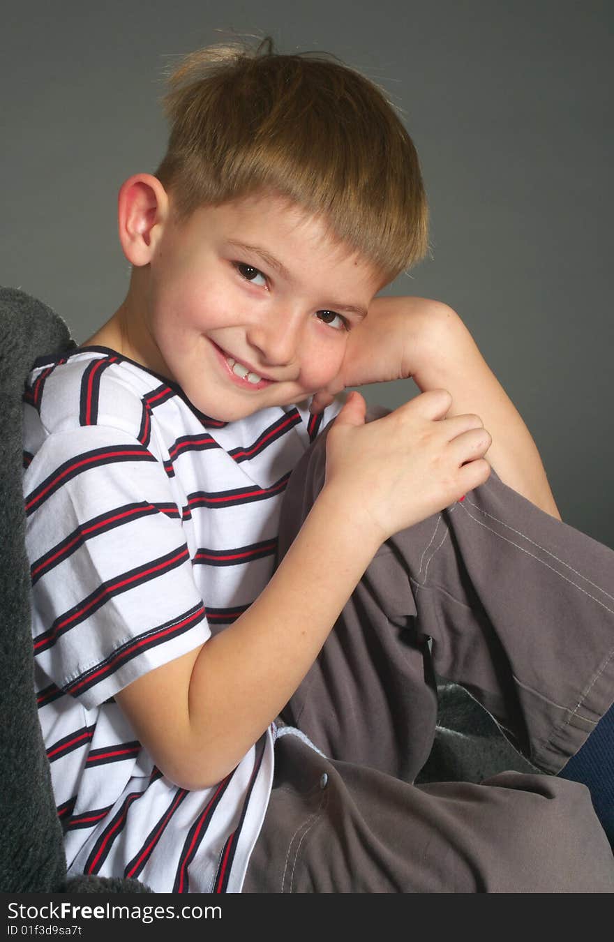 Smiling boy on gray background