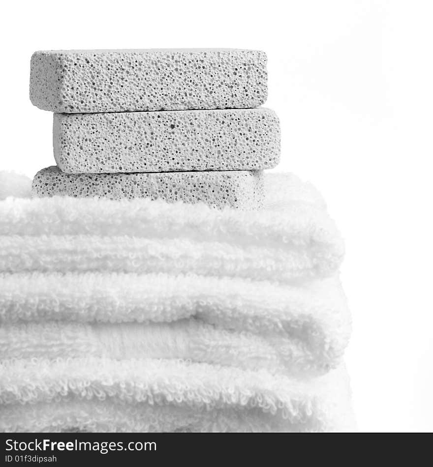 Pumice stones and towels against a white background. Pumice stones and towels against a white background.