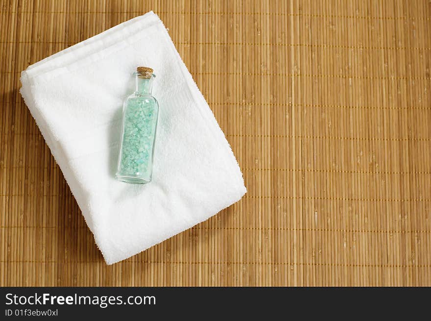 Bottle of bath salt and towel on display. Bottle of bath salt and towel on display.