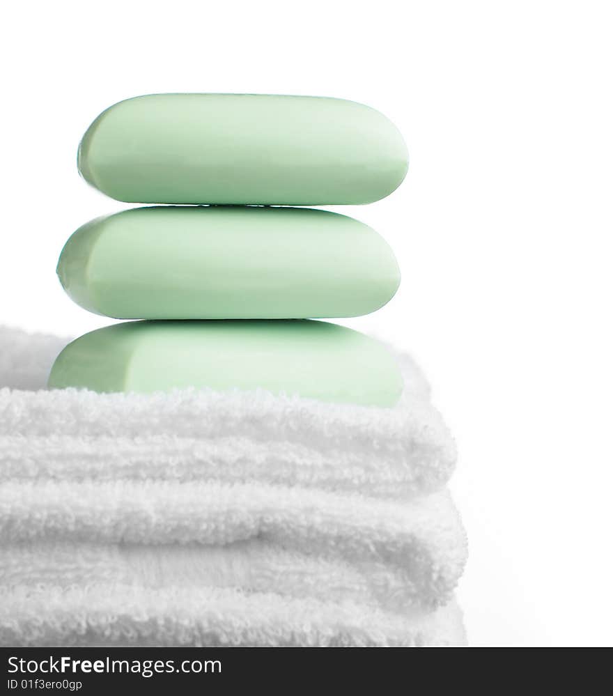 Stack of soap bars and towels against white. Stack of soap bars and towels against white.