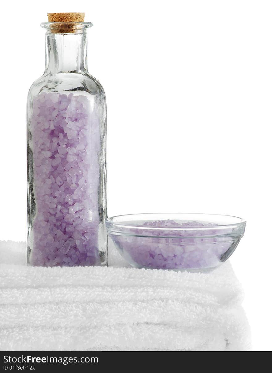 A spa scene on top of fluffy white towels against a white background.