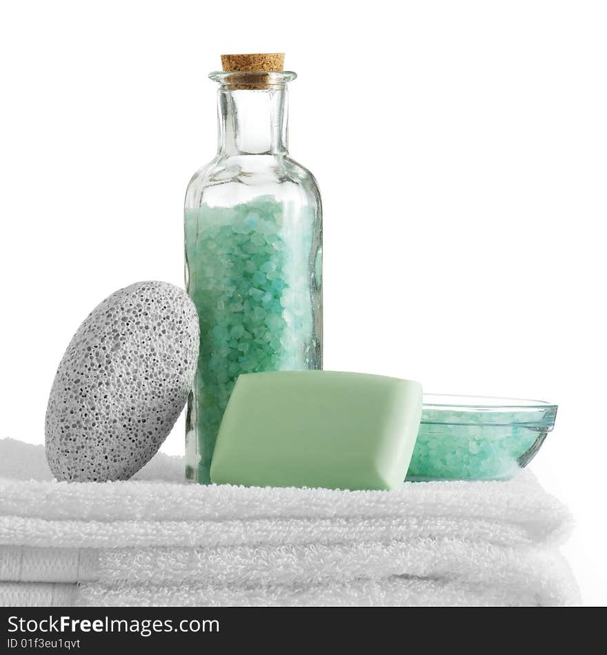 A spa scene on top of fluffy white towels against a white background.