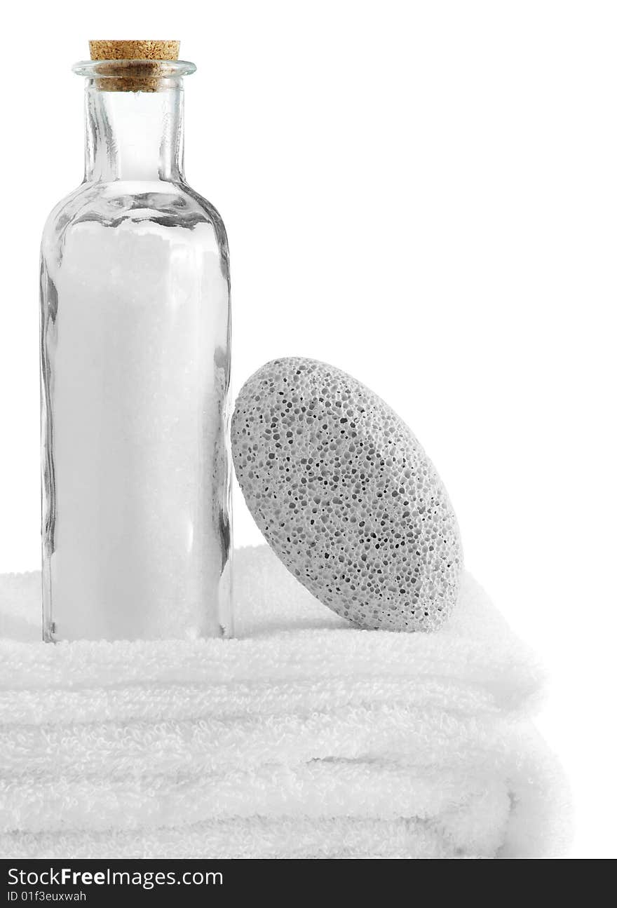 A spa scene on top of fluffy white towels against a white background.