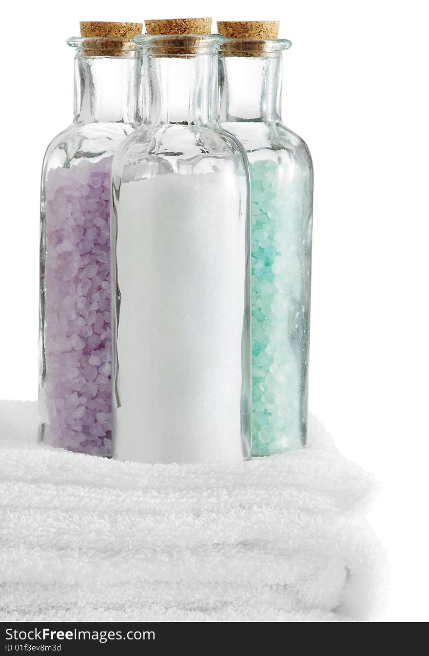 A spa scene on top of fluffy white towels against a white background.