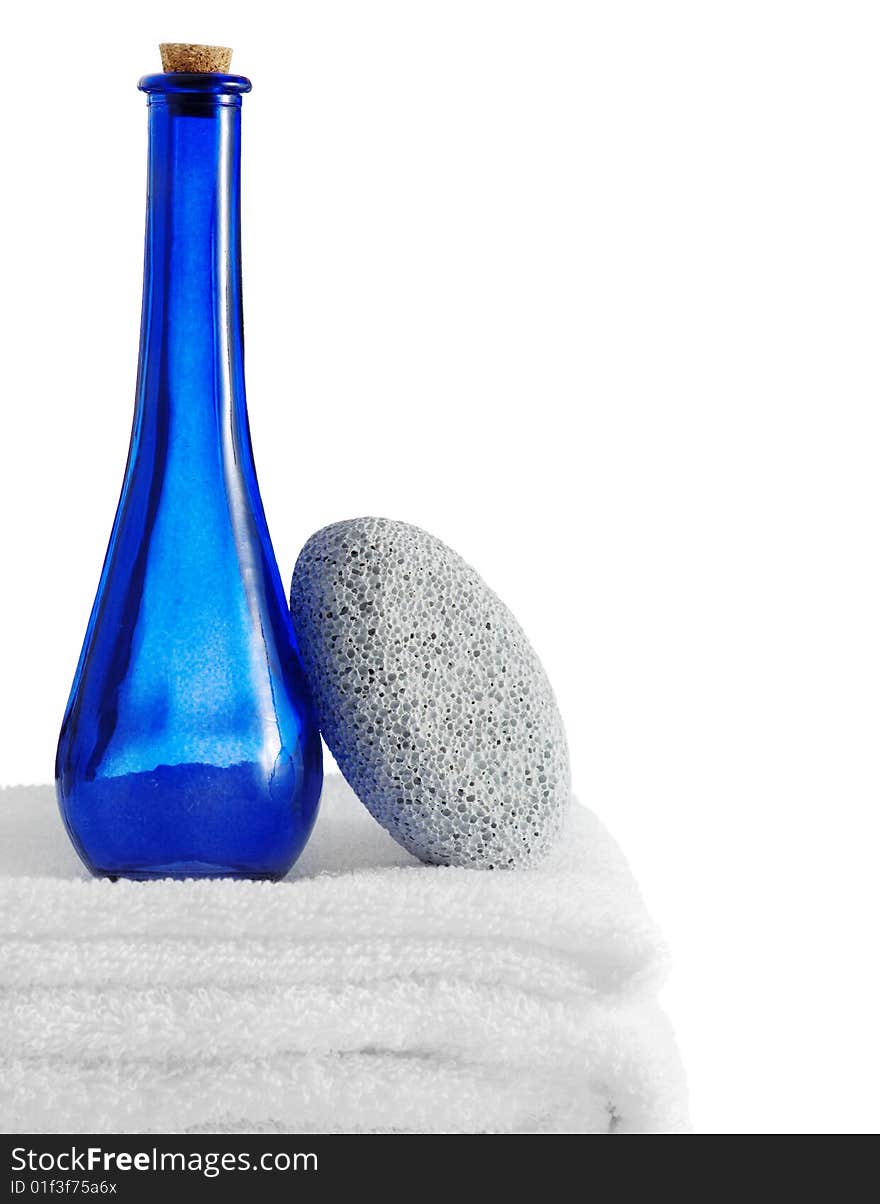 A spa scene on top of fluffy white towels against a white background.