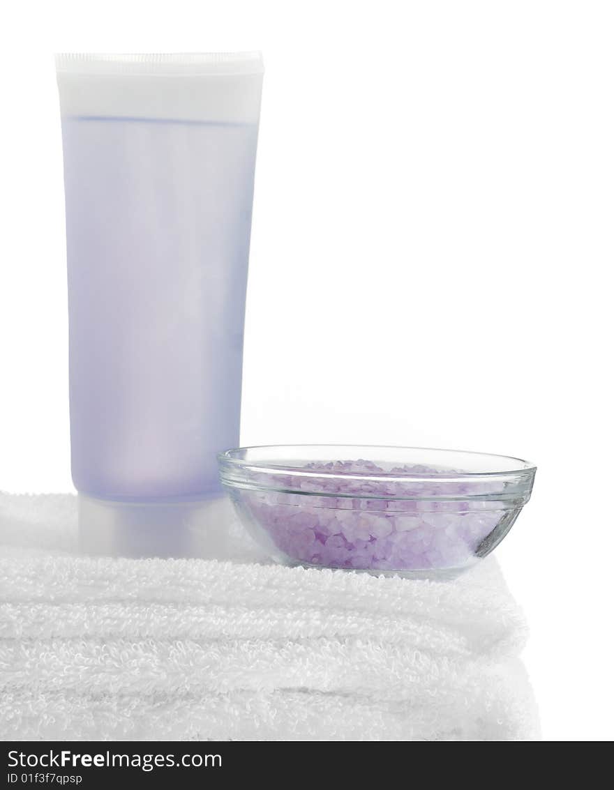 A spa scene on top of fluffy white towels against a white background.