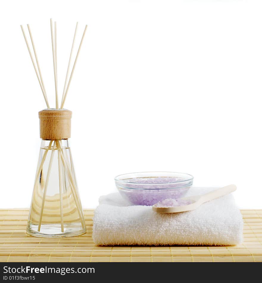 Spa scene on top of a bamboo mat and against a white background.