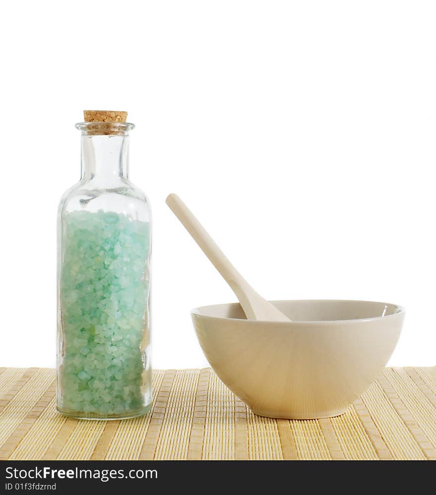 Bottle of salt and bowl of treatment against a white background. Bottle of salt and bowl of treatment against a white background.