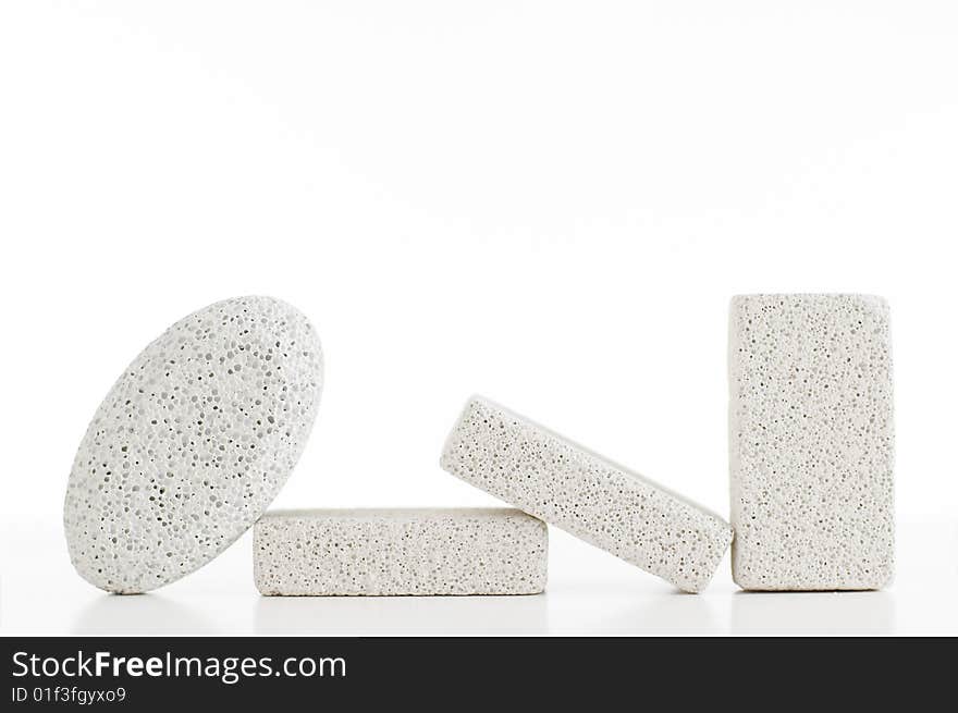 Pumice stones against a white background, sleight reflection. Pumice stones against a white background, sleight reflection.