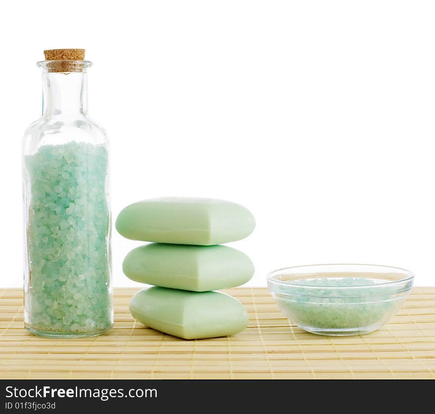 Spa scene on top of a bamboo mat against a white background.