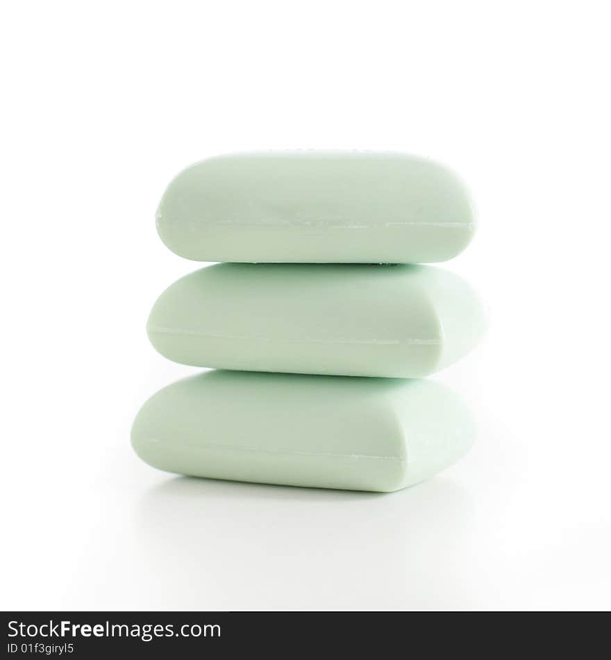 Stack of green soap bars against a white background. Stack of green soap bars against a white background.