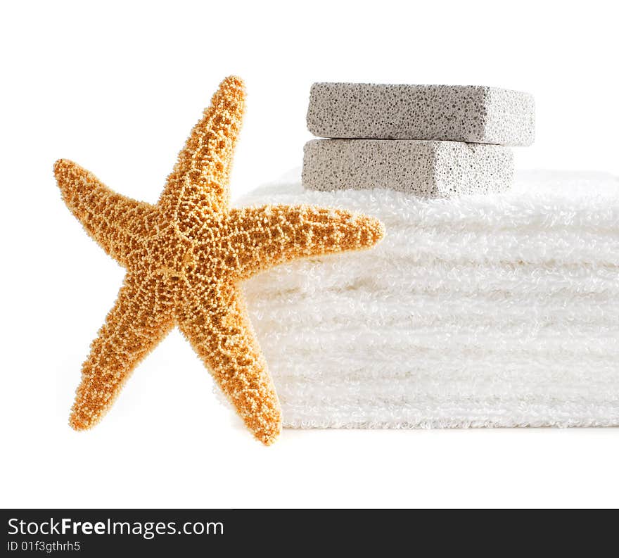 Starfish, towels, and pumice stones against a white background. Starfish, towels, and pumice stones against a white background.