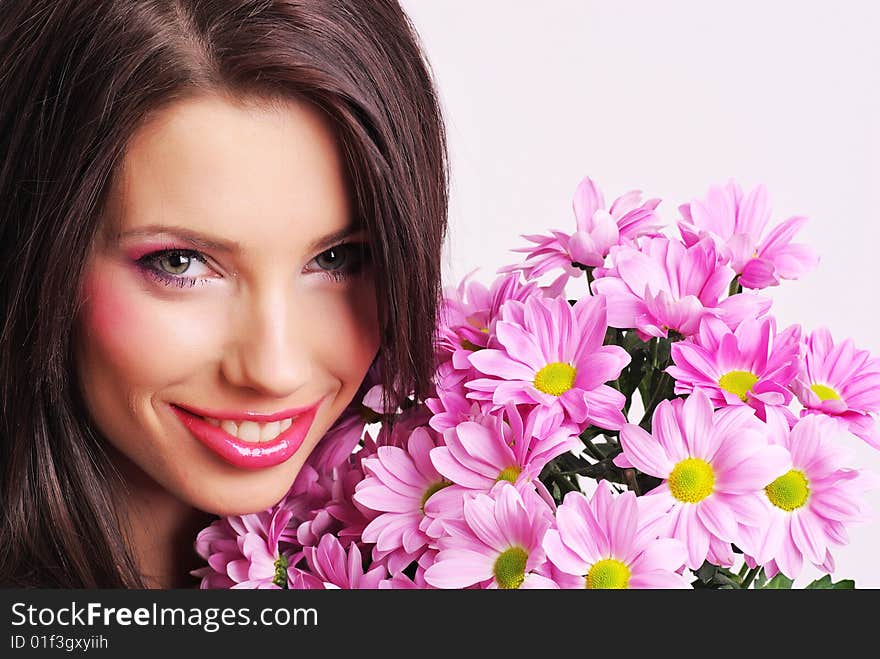 Attractive young woman face with flowers. Attractive young woman face with flowers