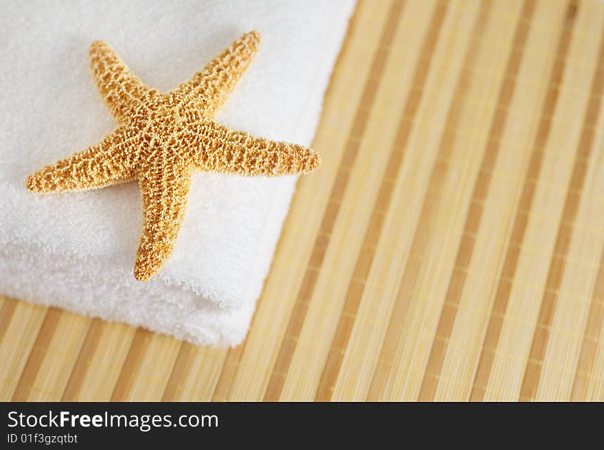 Starfish and towels on a bamboo mat. Starfish and towels on a bamboo mat.