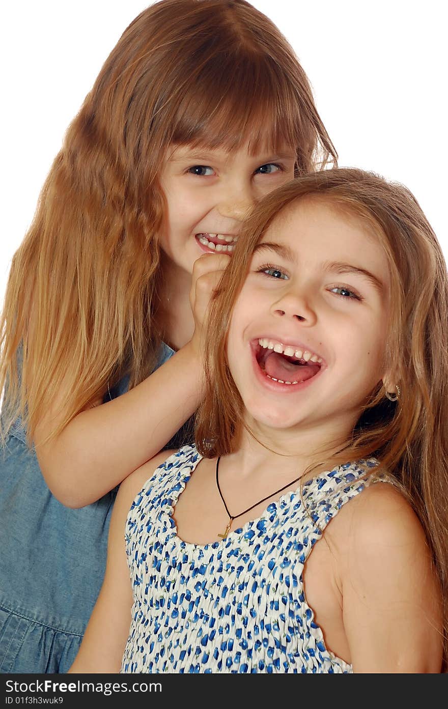 Two little laughing girls telling each other  fun secrets. Two little laughing girls telling each other  fun secrets