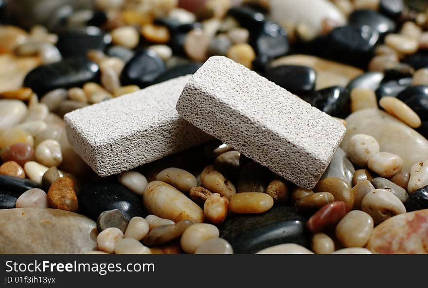 Pumice stones on display on top of river rocks. Pumice stones on display on top of river rocks.