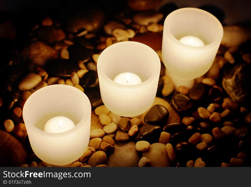 Candels buring at night on top of rocks. Candels buring at night on top of rocks.