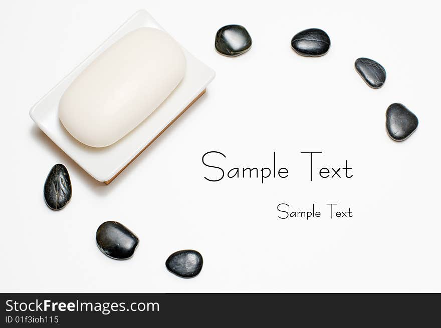 Soap dish and black rocks against a white background. Soap dish and black rocks against a white background.